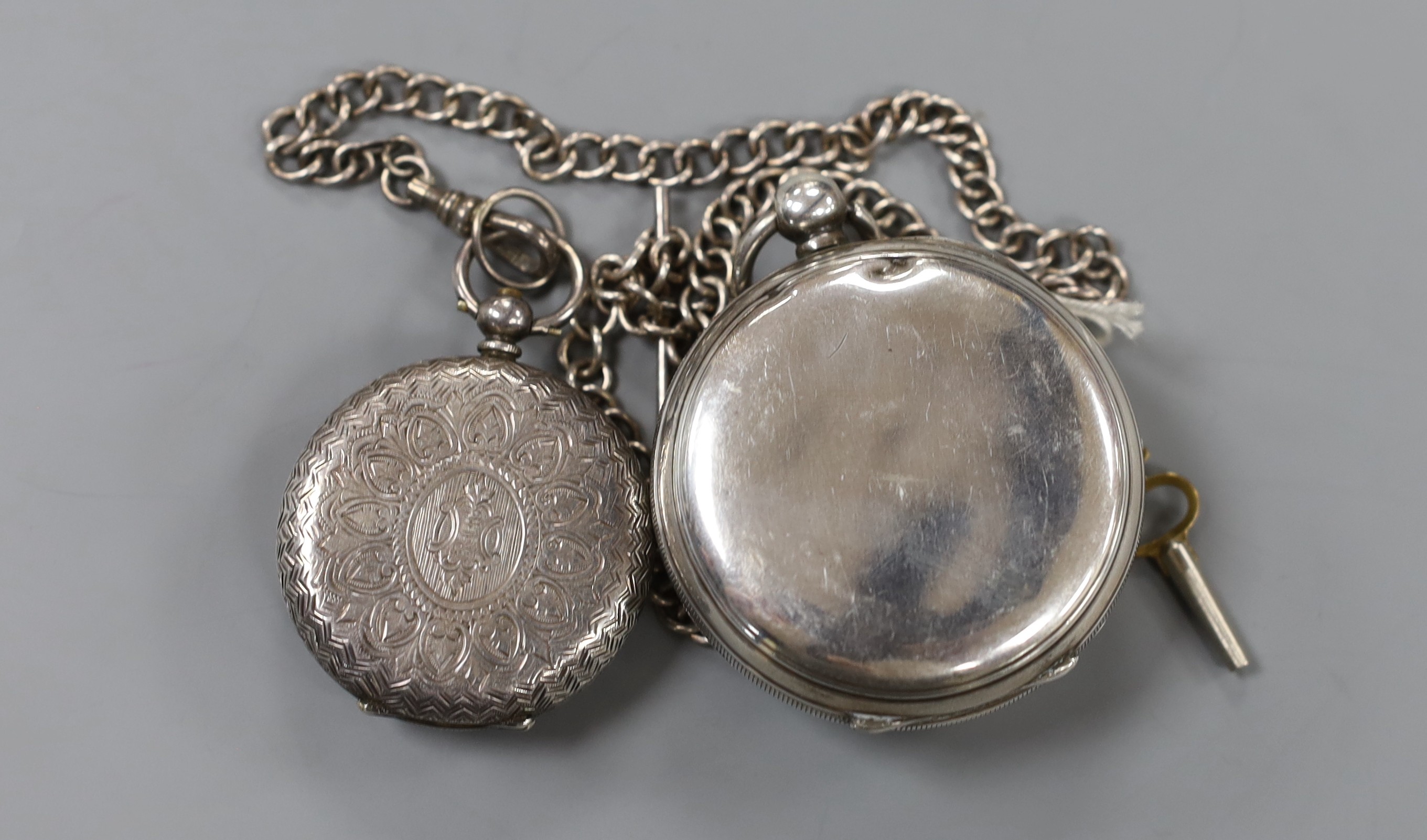 An Edwardian Waltham silver open face keywind pocket watch and a Swiss 935 white metal fob watch, on a white metal albert.